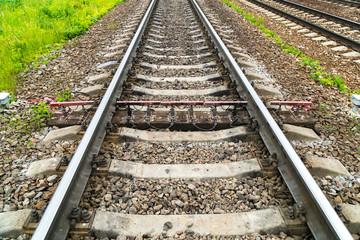 Fototapeta premium Old rusty railway. Between the concrete sleepers is one wooden sleeper with measuring sensors