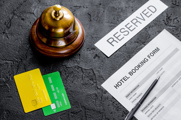 hotel reception desk with booking form dark background