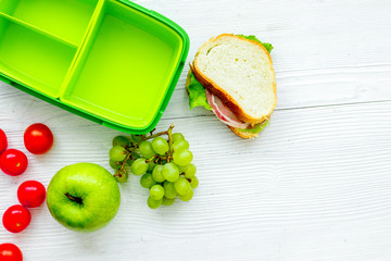 school lunch set with apple and vegetables in lunchbox backgroun