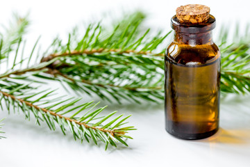 aromatherapy with organic spruce oils in glass bottles on white 