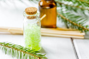 spa with organic spruce oil and sea salt in glass bottles on whi