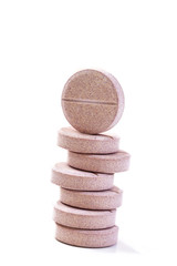 Fototapeta na wymiar Stack of vitamin mineral supplement effervescent tablets on a white background
