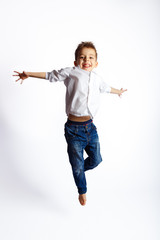 A boy jumping with happy face on white background.
