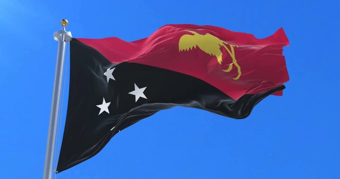 Flag of Papua New Guinea waving at wind with blue sky in slow, loop