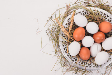 Chicken raw eggs on a metal plate. On a wooden background. Top view. Copy space.