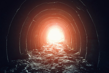 Mysterious light in the end of tunnel. Escape and exit to freedom and hope concept. Abandoned...