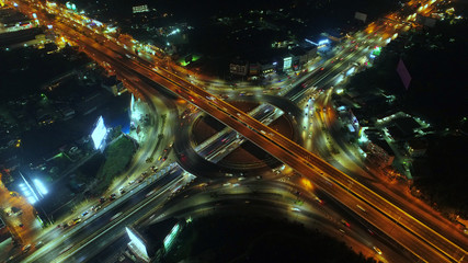 Fototapeta na wymiar Aerial view, Road roundabout, Expressway with car lots in the city in Thailand. beautiful Street , downtown, cityscape, Top view. Background