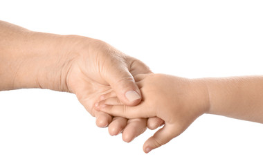Hands of elderly man and baby on white background