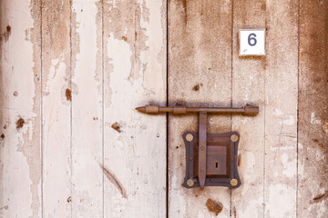 Wooden antique door with lock bolt. Ancient door.
