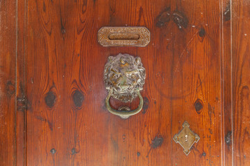 Old iron door handle on a wooden door. Old Iron Door Handle.