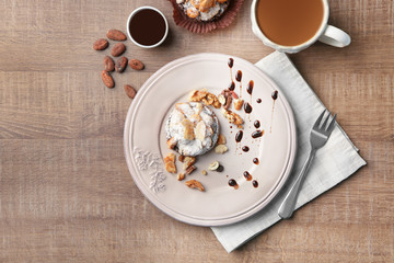 Plate with tasty praline cake on table