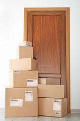 Fototapeta premium Delivered parcels on floor near front door