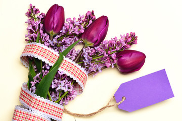 Tulips and lilac flowers with rustic ribbon and price tag