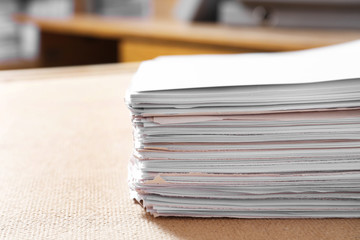 Stack of old paper documents on table in archive, closeup