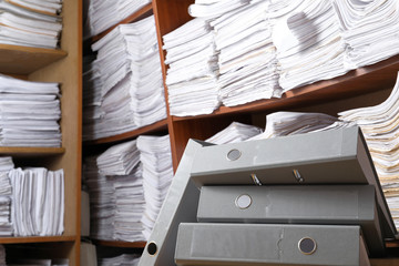 Folders and shelves with old paper documents in archive