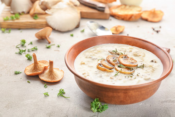 Bowl with mushroom soup on table