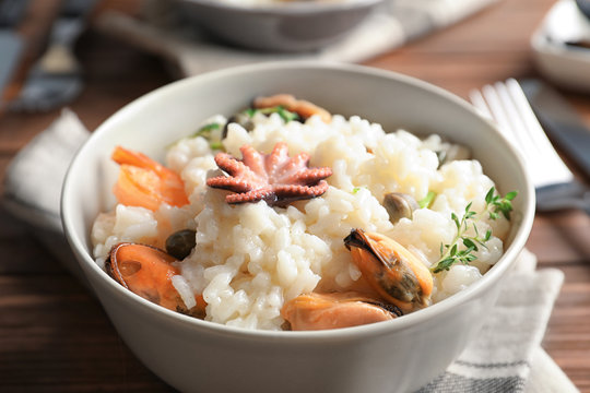 Dish with delicious seafood risotto on table, closeup