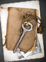Rusty key, old book and empty photography as a memories  metaphor. Copy space