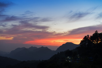 Amazing sunset.Natural Sunset Sunrise Over Mountain. Bright Dramatic Sky And Dark Ground.Colorful sky in the sunset.