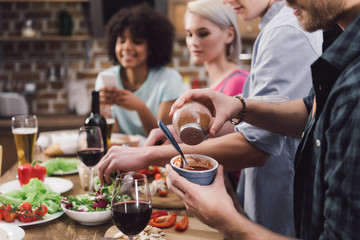 cropped image of man adding spice to sauce