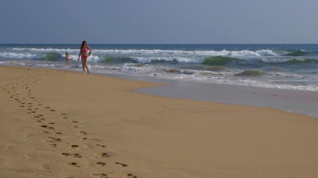 Woman Walks From  Indian Ocean; Club Villa; Bentota, Sri Lanka