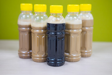 Ice coffe latte and black coffee in bottles