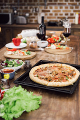 homemade delicious pizza on table in kitchen
