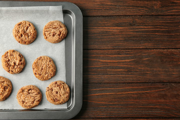 Delicious oatmeal cookies with chocolate chips on baking sheet