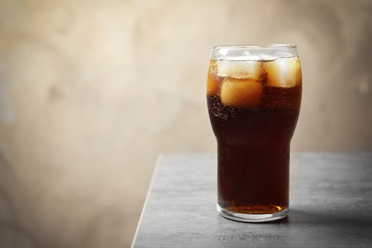 Cold cola in glass on table