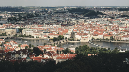 Fototapeta premium Panorama of Prague, the Vltava river and Charles Bridge. Photo in retro style