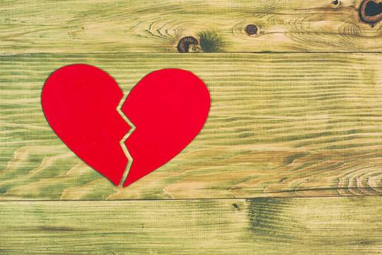 Broken heart  on wooden table,relationship breakup concept.