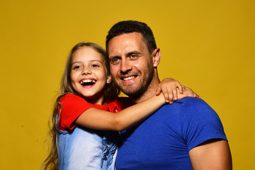 Obraz premium Family time and parenthood concept. Man and girl hug