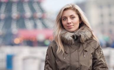 Fototapeta premium Portait of beautiful blonde woman with blurred bokeh light background.