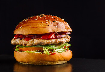 Hamburger on a black slate board.