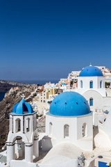 Naklejka premium Santorini it's one of the most beautiful destination in Greece. The cities with with houses and blue roofs are a timeless symbol of this breathtaking island.