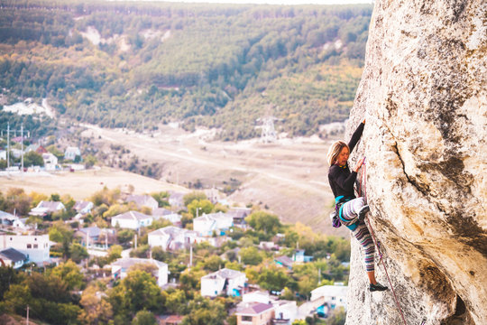 Girl climbs the rock.