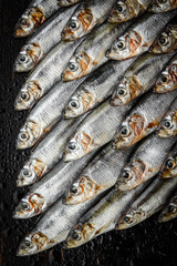 Obraz premium fresh raw fish anchovy and sprat on a wooden surface