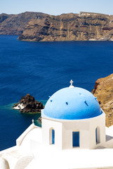 Fototapeta na wymiar Blue roof church on Santorini island in Greece