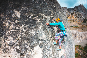 The girl climbs the rock.