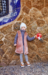 elegant child in Barcelona, Spain showing Christmas gift