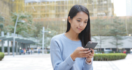 Woman use of cellphone at outdoor