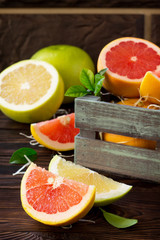 Fresh and juicy red grapefruit and pomelo on a wooden table. Still life, diet and nutrition concept.