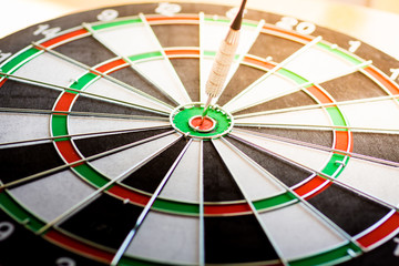 Dart arrow hitting in the target center of dartboard using as background Target business, achieve and victory,success concept.