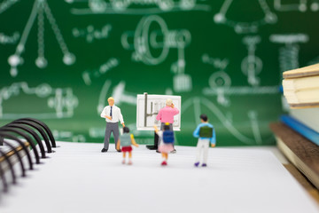 Miniature people : children studying with teacher. Image use for back to school concept