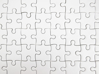 White jigsaw puzzle pieces completed as copy space