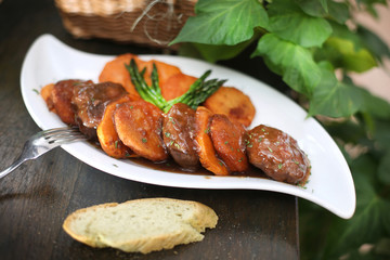 Steak medallions with sweet potato in brown sauce