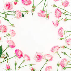 Floral round frame made of pink roses, buds and leaves on white background. Valentines day. Flat lay, Top view.