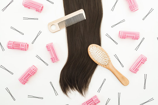 Hairdresser tools for hair styling and curlers on white background. Beauty composition. Flat lay, top view