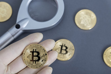 Bitcoin with a magnifying glass