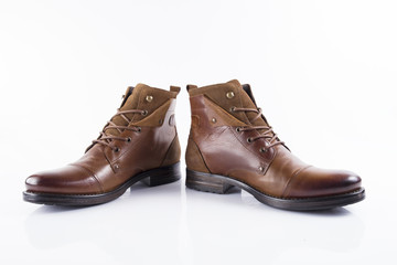 Male brown leather boot on white background, isolated product, comfortable footwear.